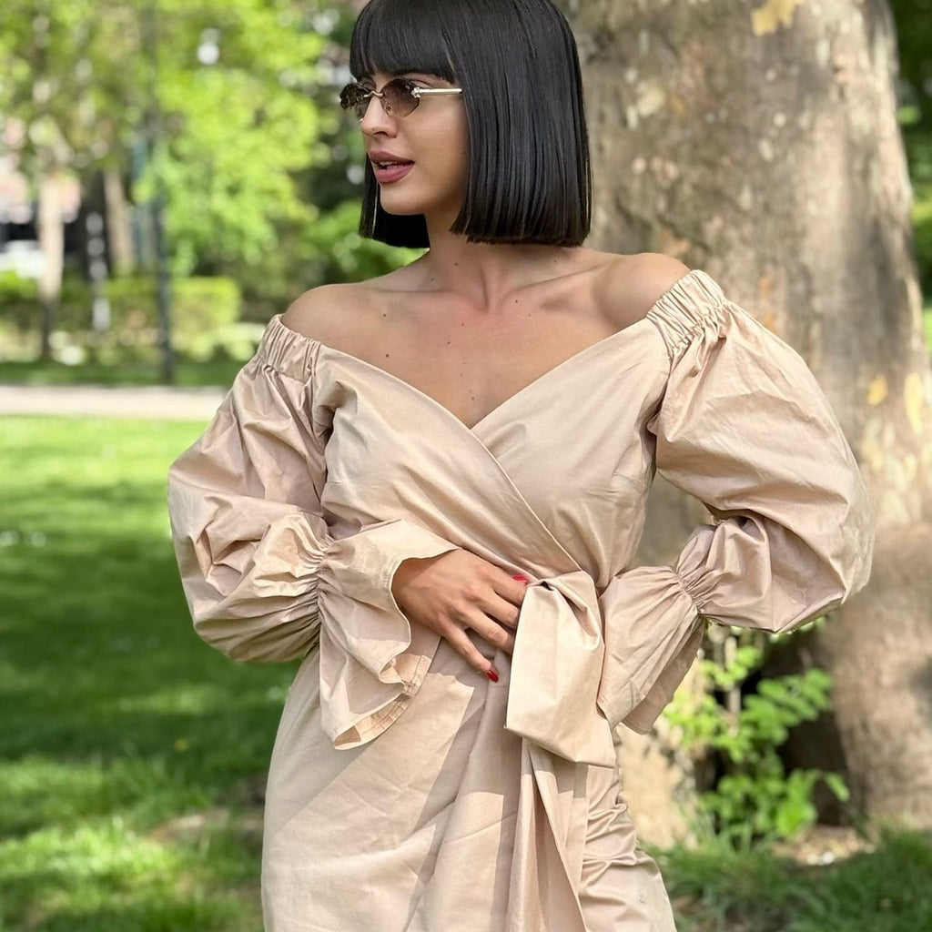 woman wearing off shoulder tan dress in park woman wearing off shoulder tan dress in park