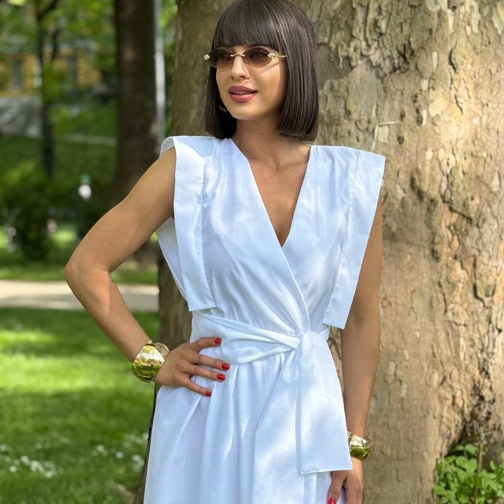 woman in sleeveless white wrap dress outdoors woman in sleeveless white wrap dress outdoors