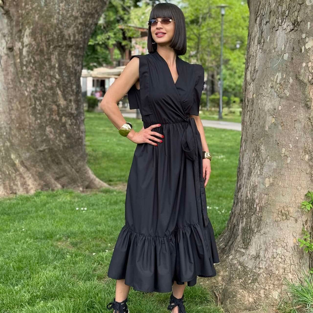 person wearing black sleeveless maxi dress with heels in park person wearing black sleeveless maxi dress with heels in park