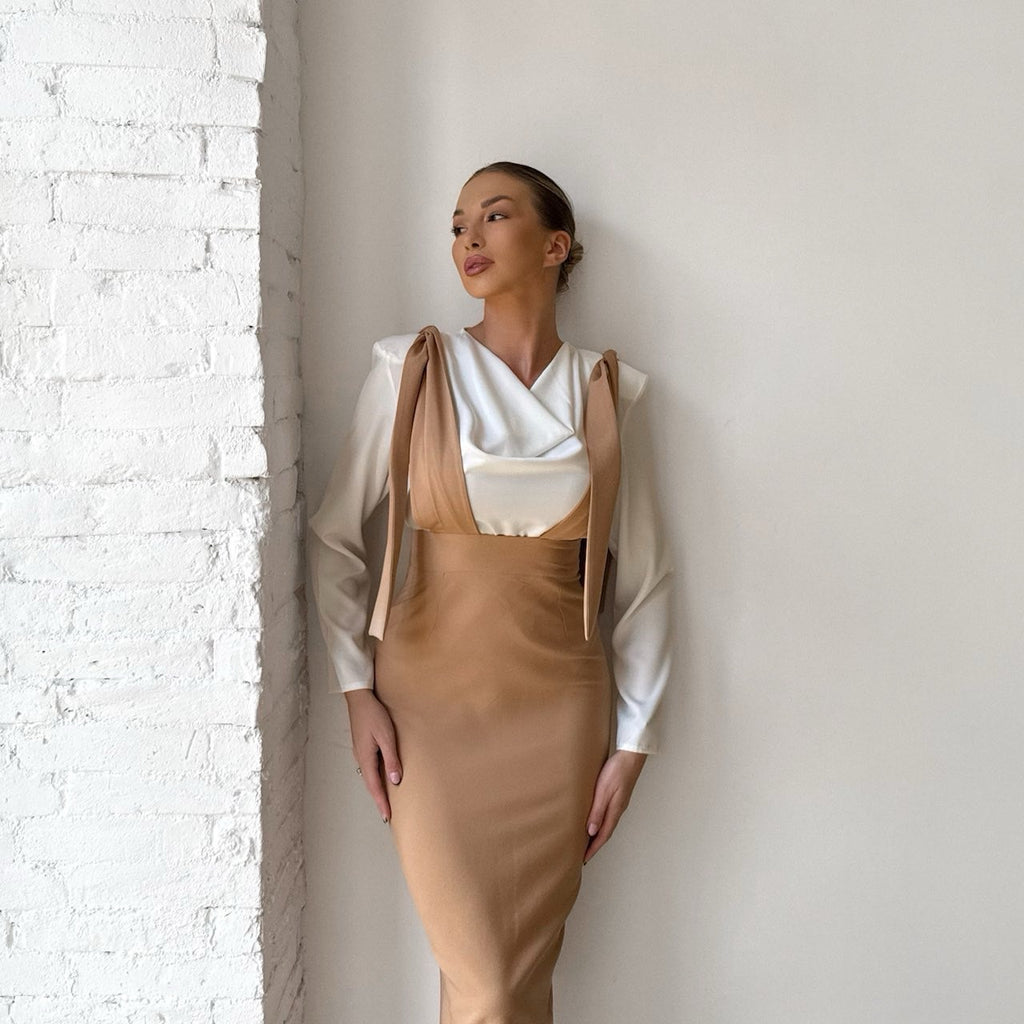 elegant woman in tan pinafore dress with white blouse elegant woman in tan pinafore dress with white blouse
