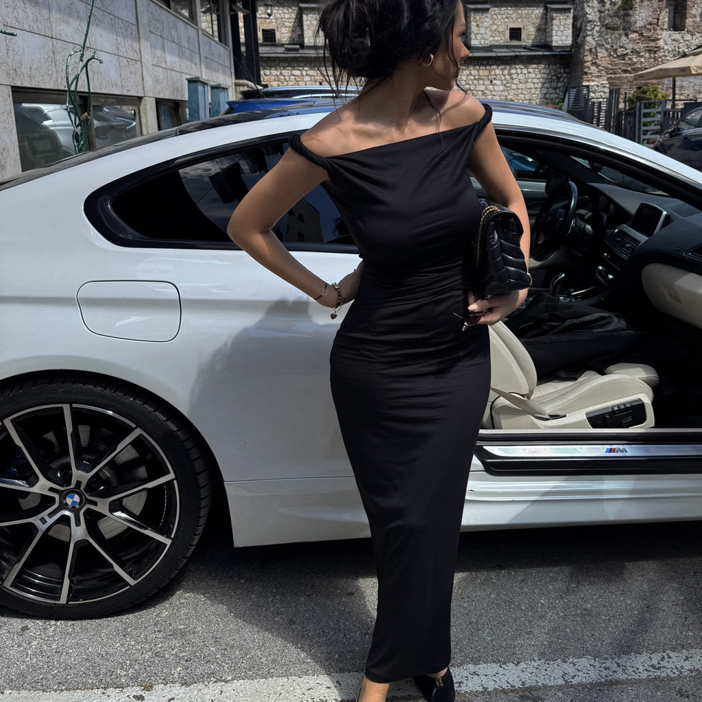 woman wearing elegant black evening dress near white car woman wearing elegant black evening dress near white car