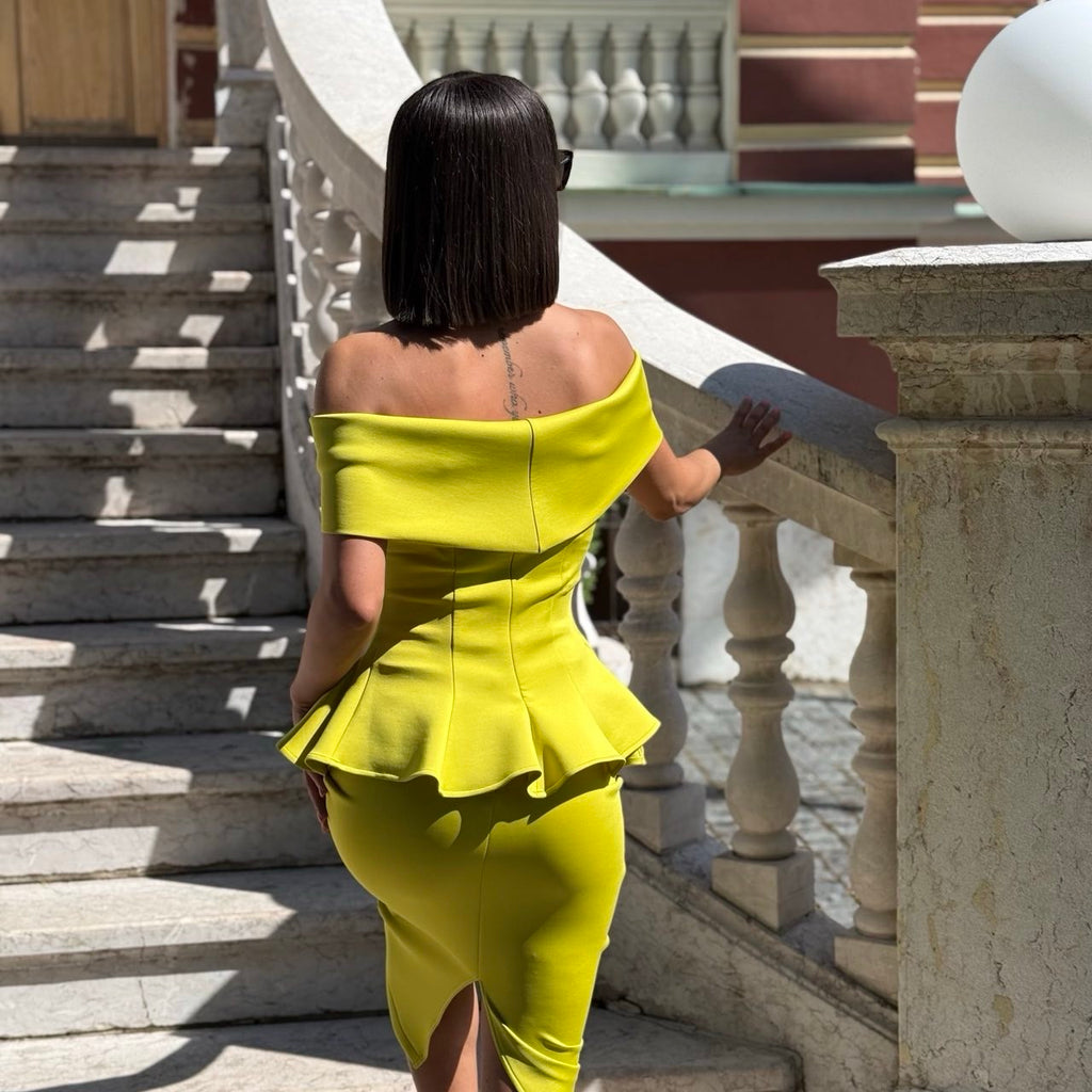 woman wearing yellow off shoulder dress walking up stairs woman wearing yellow off shoulder dress walking up stairs