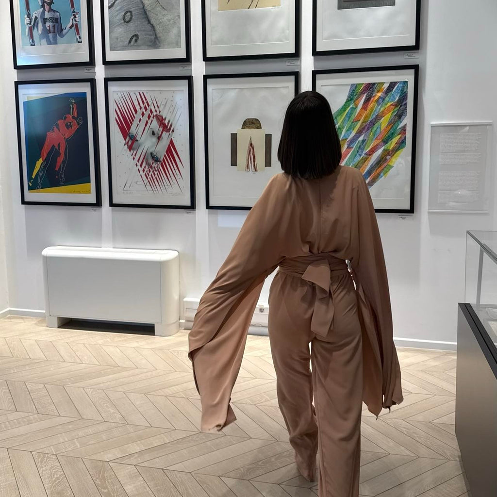 woman in elegant beige dress in art gallery woman in elegant beige dress in art gallery
