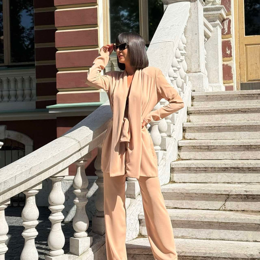 beige elegant pantsuit on woman outdoors on staircase beige elegant pantsuit on woman outdoors on staircase