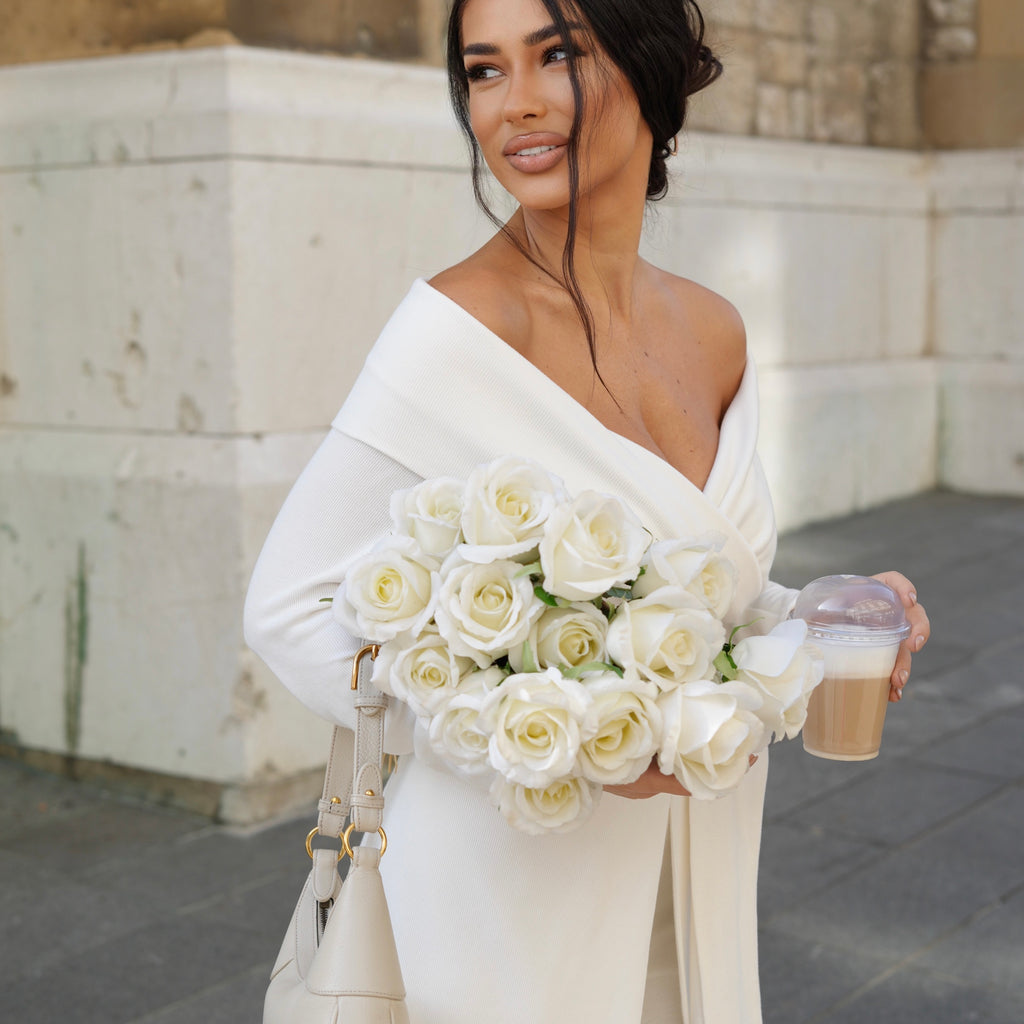 woman in elegant white dress holding roses and coffee cup woman in elegant white dress holding roses and coffee cup