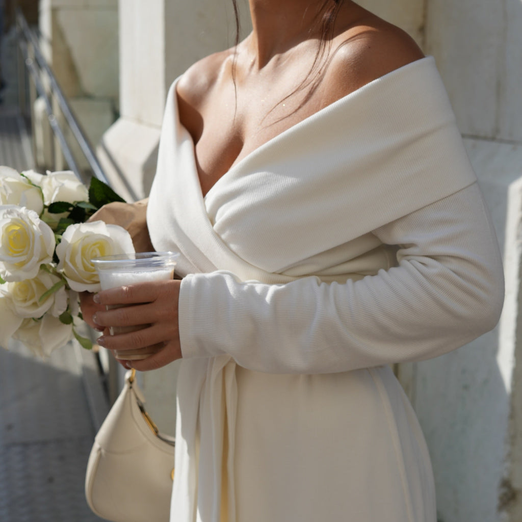 woman in off the shoulder white dress holding roses and drink woman in off the shoulder white dress holding roses and drink