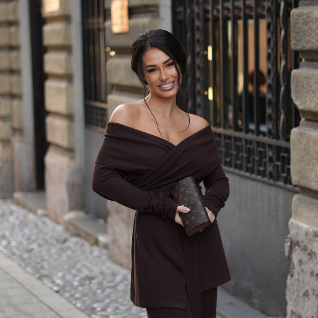 woman in brown off shoulder dress holding bag on street woman in brown off shoulder dress holding bag on street