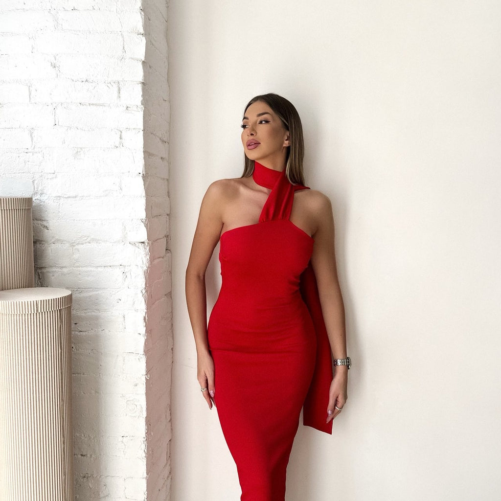 woman in red halter dress standing indoors woman in red halter dress standing indoors