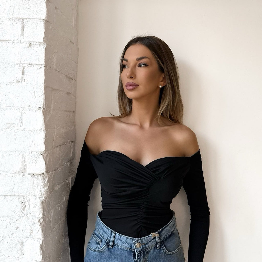 woman wearing off shoulder black top and jeans woman wearing off shoulder black top and jeans