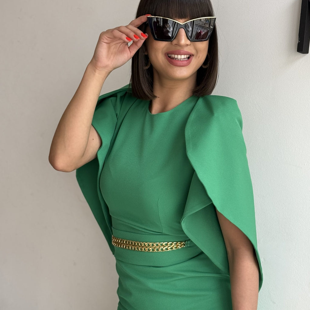 woman in green dress with gold belt and sunglasses woman in green dress with gold belt and sunglasses