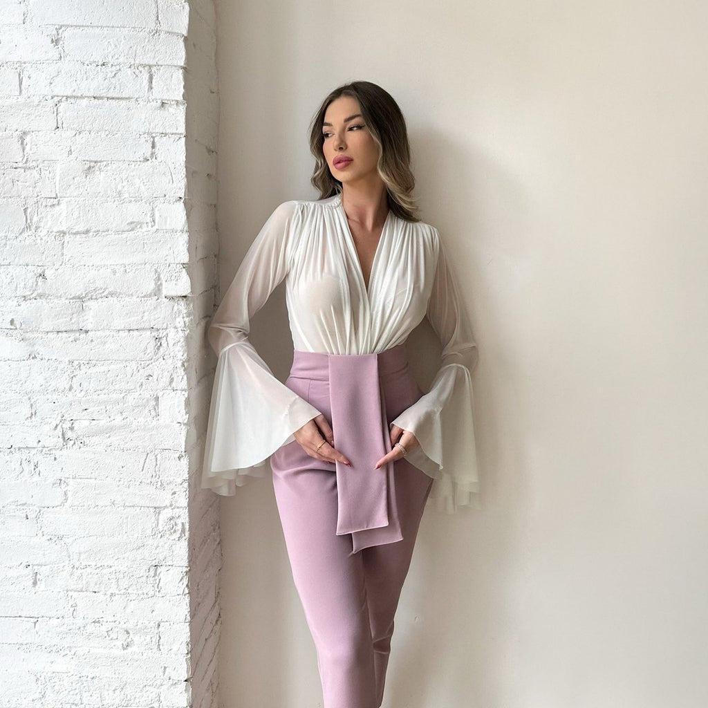 woman wearing white blouse and light purple skirt in stylish pose woman wearing white blouse and light purple skirt in stylish pose