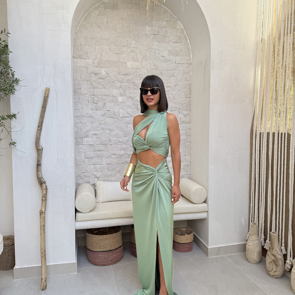 woman wearing elegant green cutout dress with sunglasses woman wearing elegant green cutout dress with sunglasses