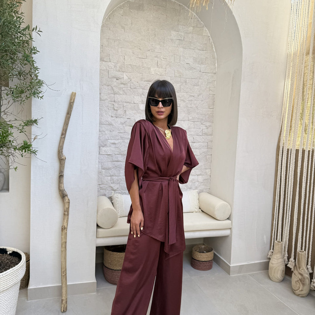 woman wearing stylish burgundy ensemble in modern interior woman wearing stylish burgundy ensemble in modern interior
