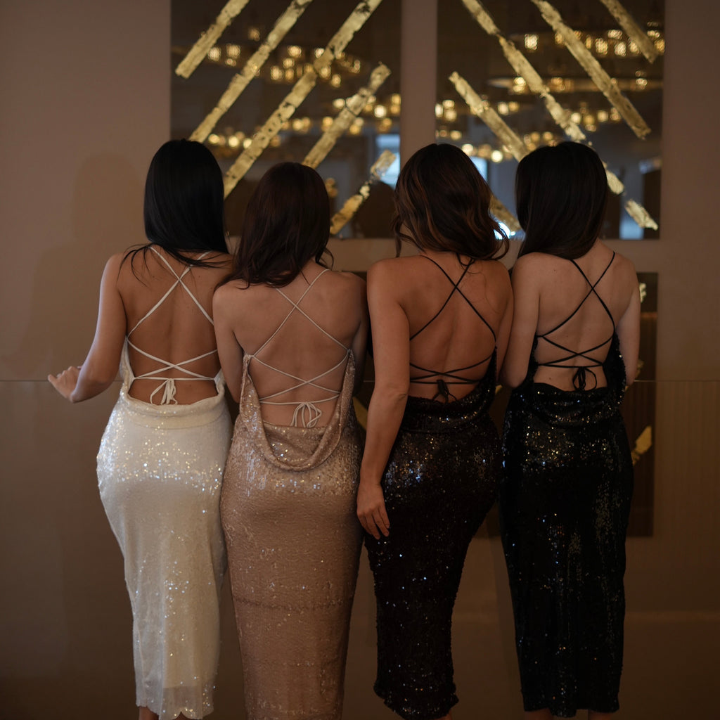 four women in sequined open back dresses four women in sequined open back dresses