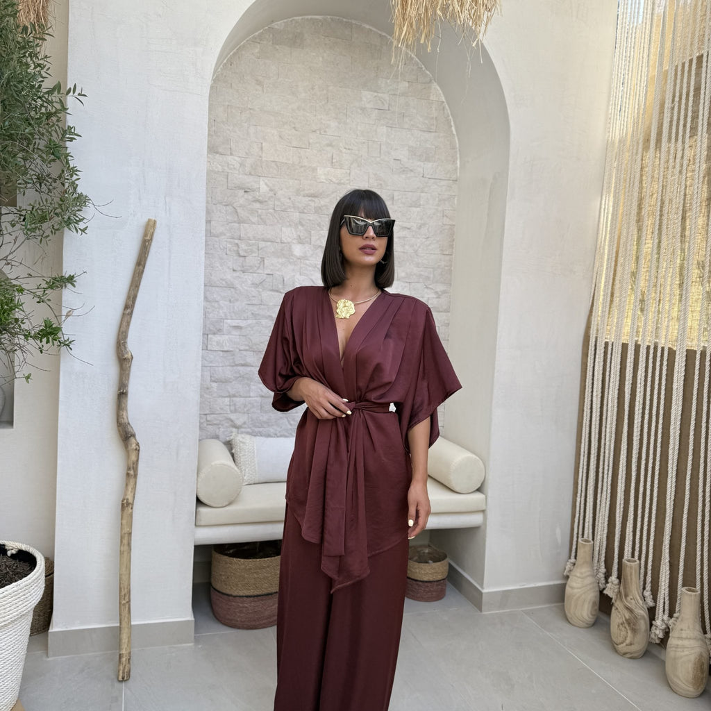 woman in burgundy wrap dress in chic room woman in burgundy wrap dress in chic room