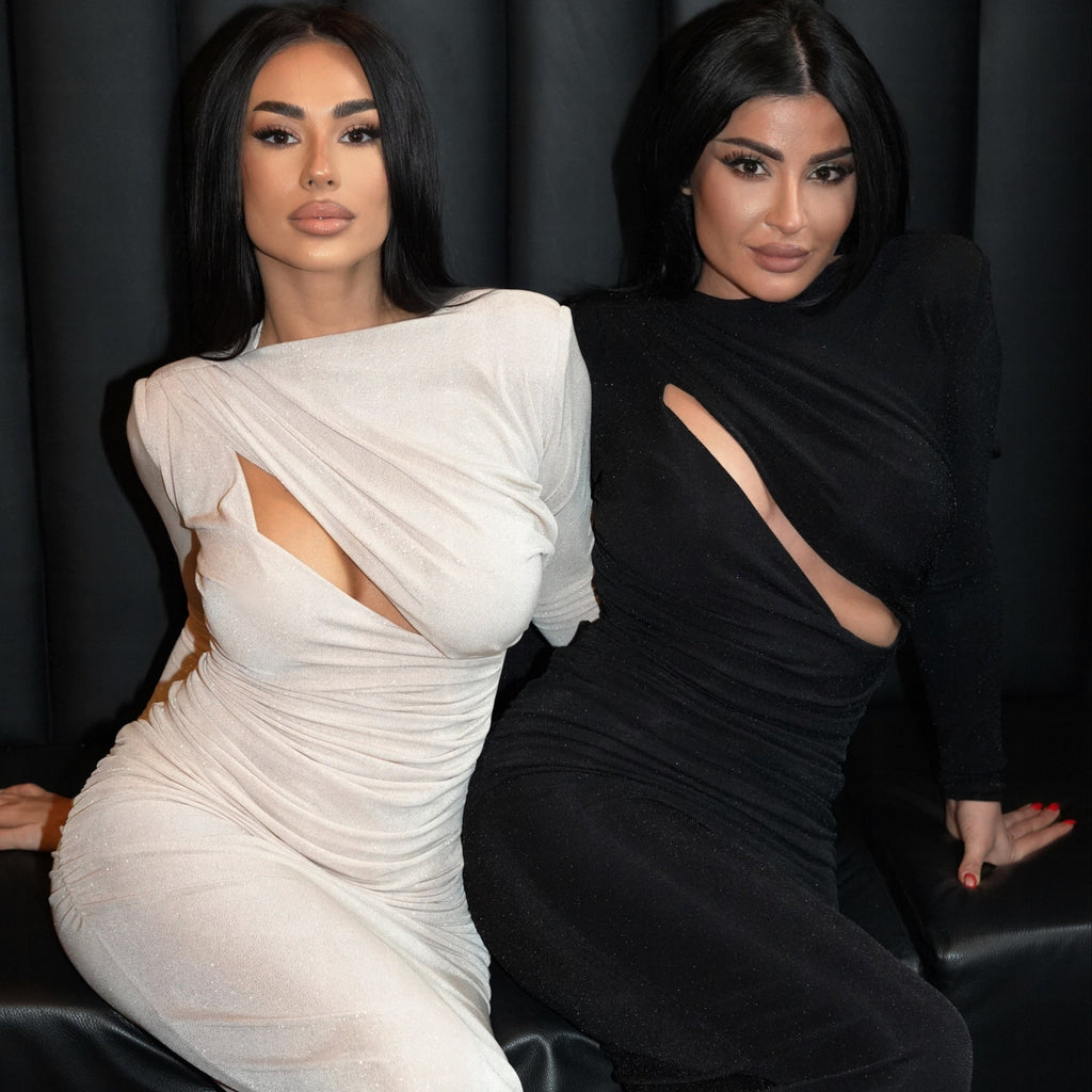 two women wearing stylish dresses one white one black two women wearing stylish dresses one white one black