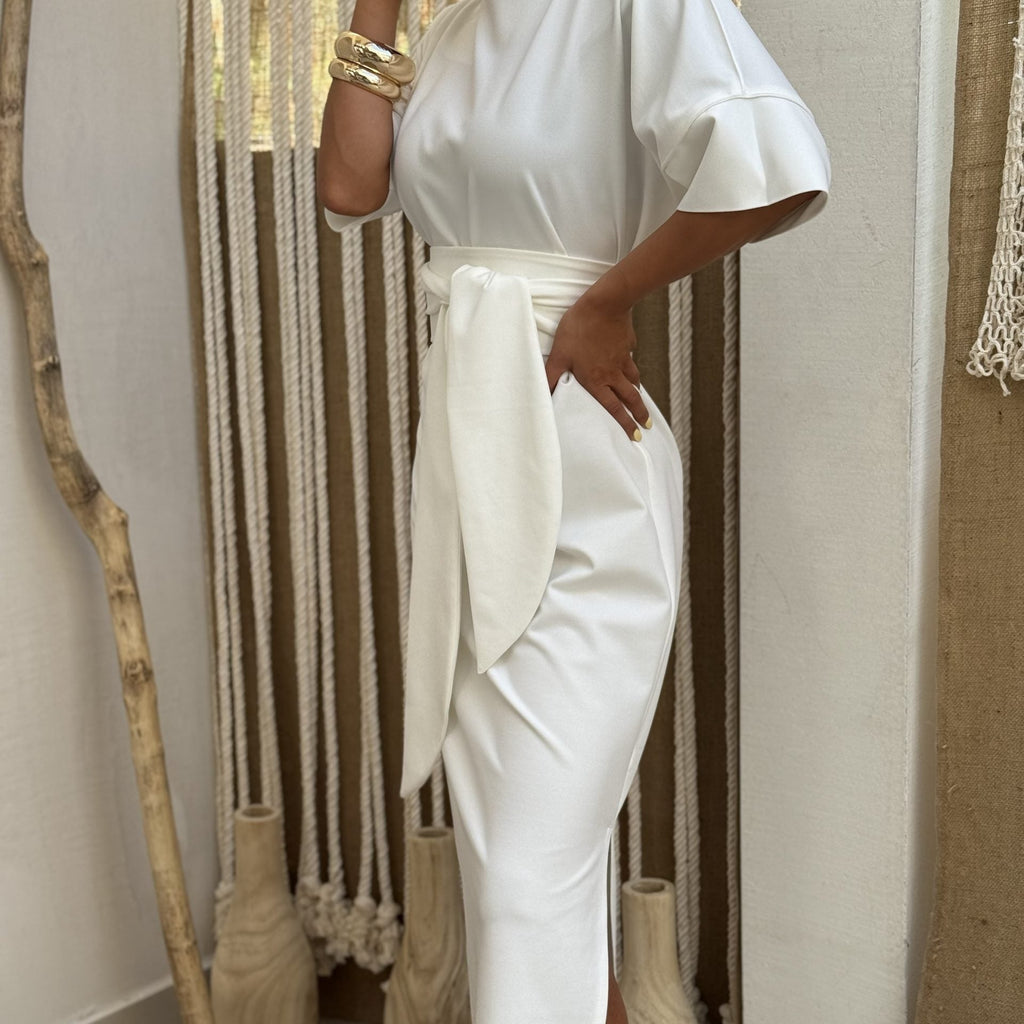 elegant white dress with tie waist and gold bracelets elegant white dress with tie waist and gold bracelets