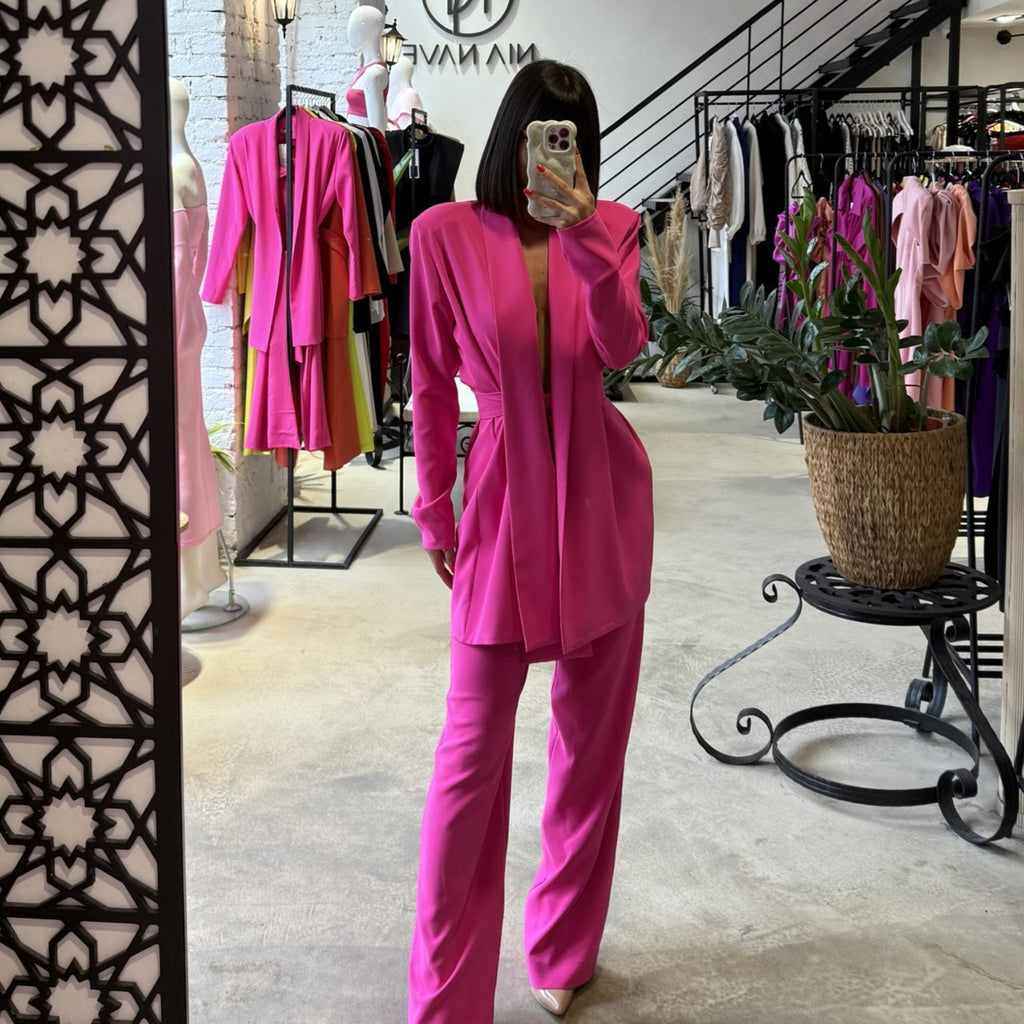 woman in pink pantsuit in clothing store woman in pink pantsuit in clothing store
