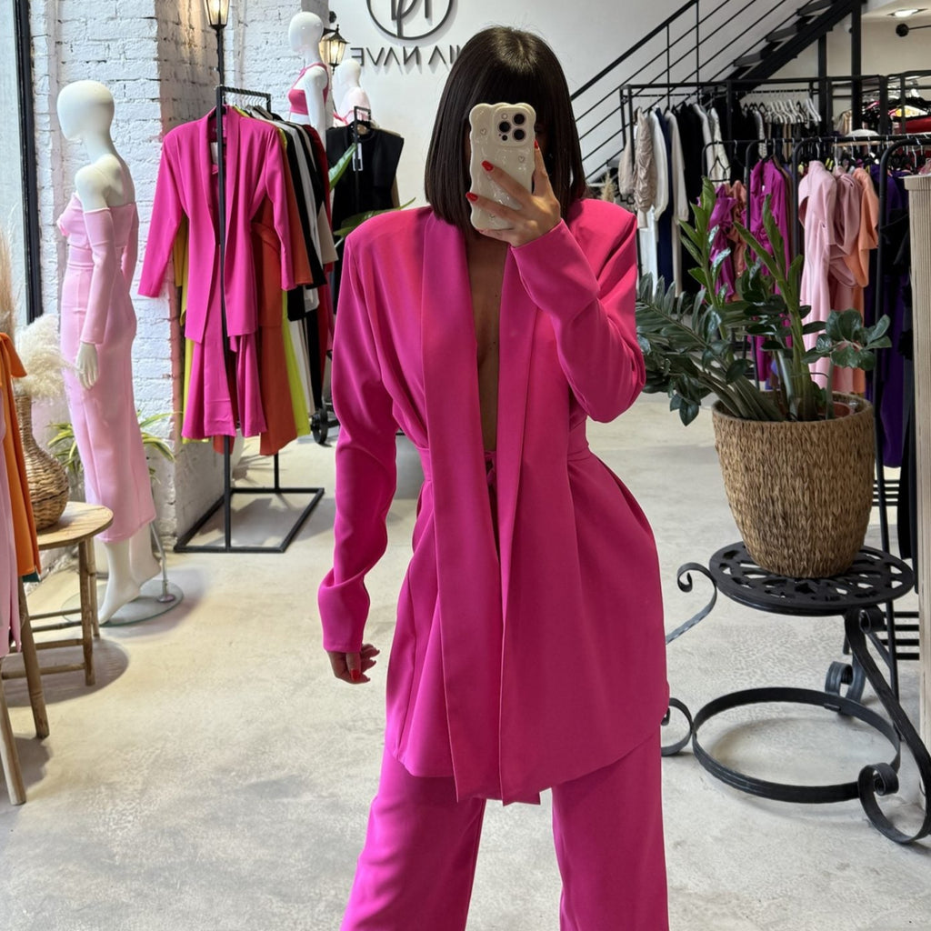 woman wearing pink suit in clothing store woman wearing pink suit in clothing store