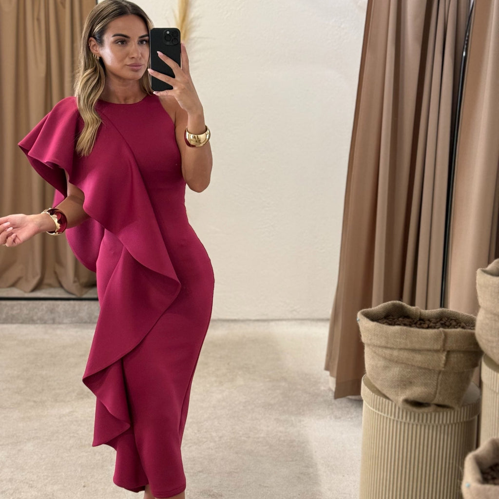 woman in pink ruffled dress in fitting room woman in pink ruffled dress in fitting room