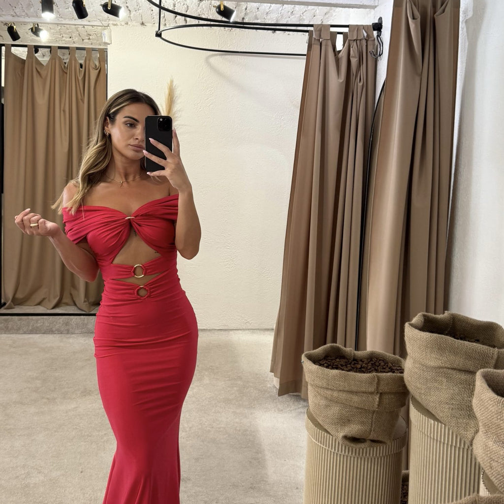 woman in fitted red dress in dressing room woman in fitted red dress in dressing room
