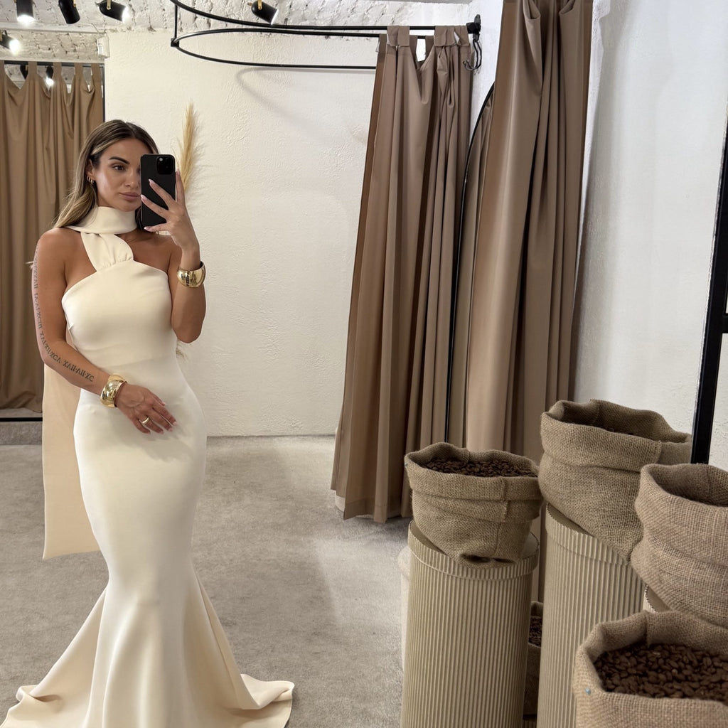 elegant cream evening gown in fitting room elegant cream evening gown in fitting room