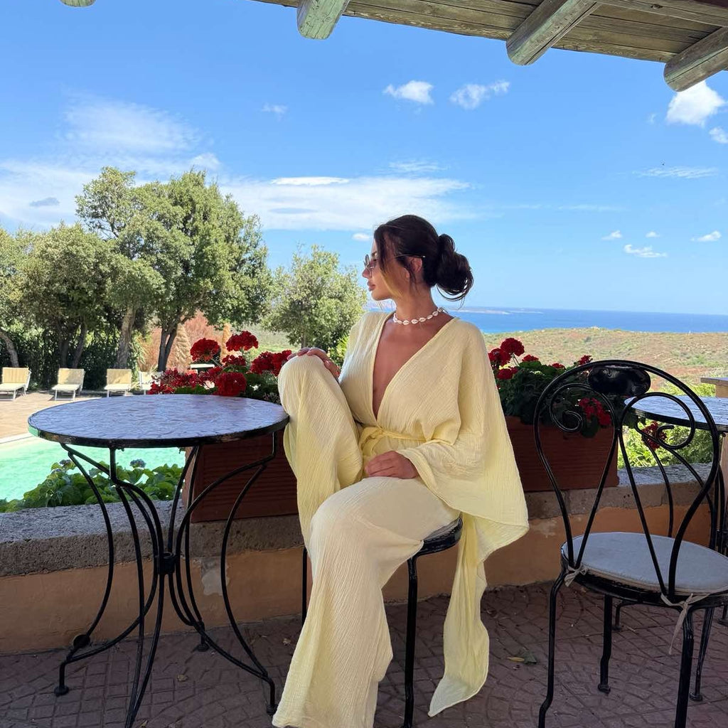woman in yellow dress sitting outdoors woman in yellow dress sitting outdoors