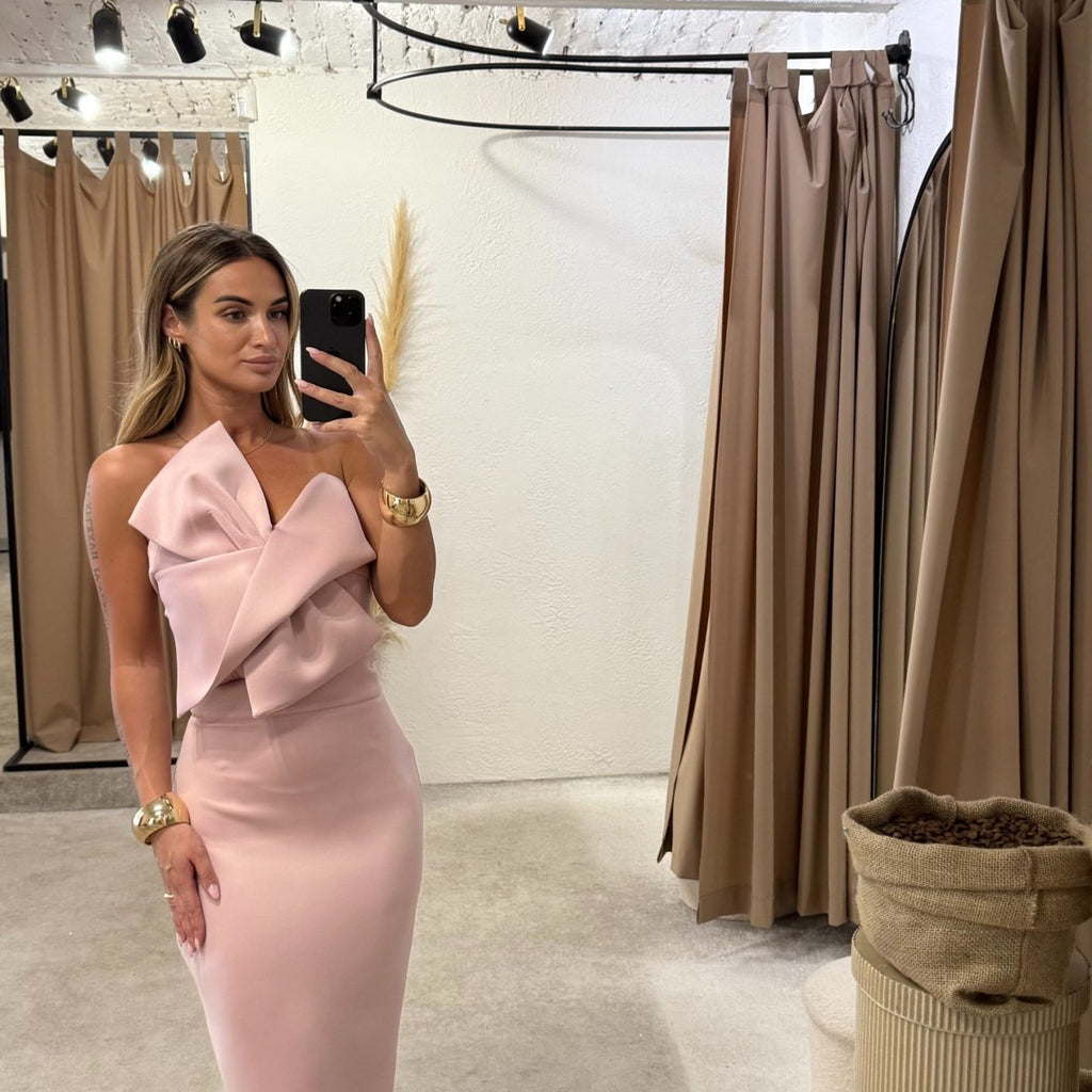 woman in pink off shoulder dress in fitting room woman in pink off shoulder dress in fitting room