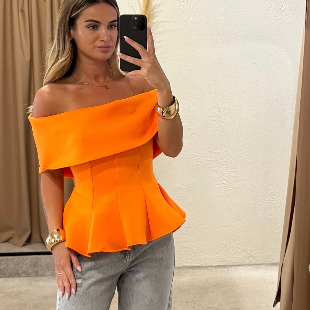 woman wearing orange off shoulder top and jeans woman wearing orange off shoulder top and jeans