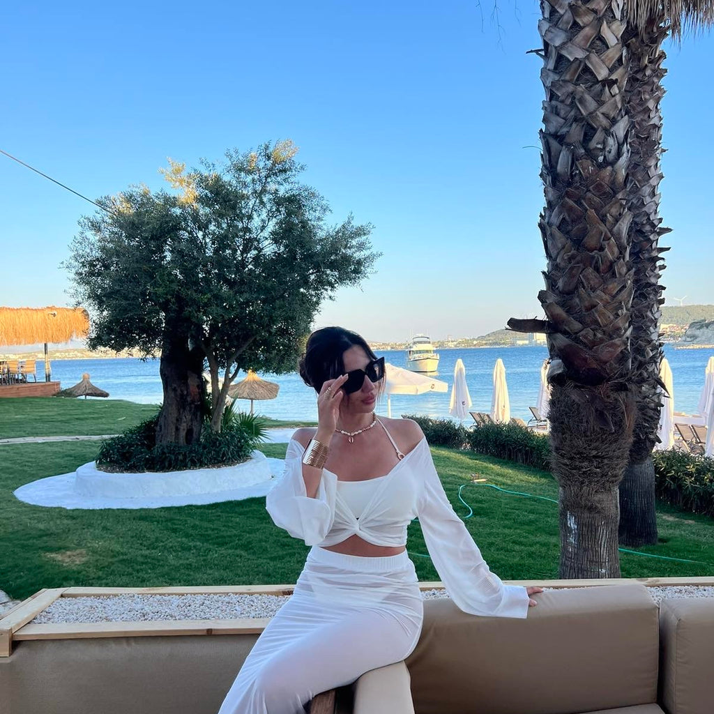 woman in white off shoulder dress by the beach woman in white off shoulder dress by the beach
