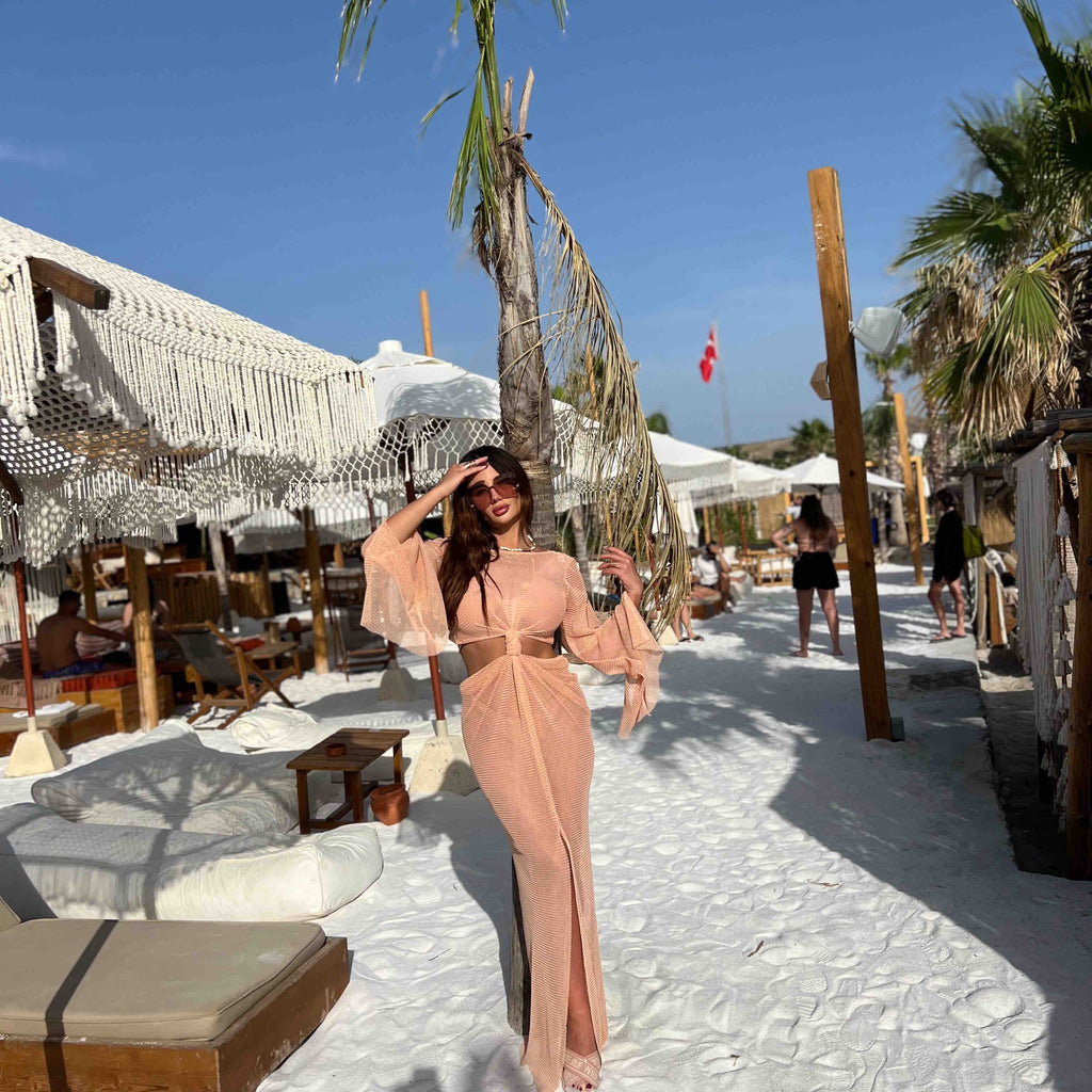 woman in beige flowy dress on beach woman in beige flowy dress on beach