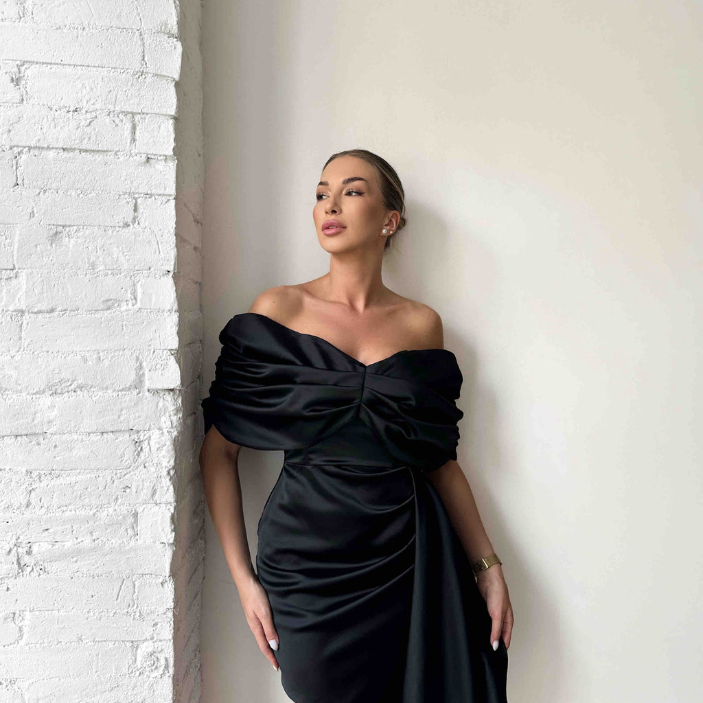 woman wearing off shoulder black dress woman wearing off shoulder black dress