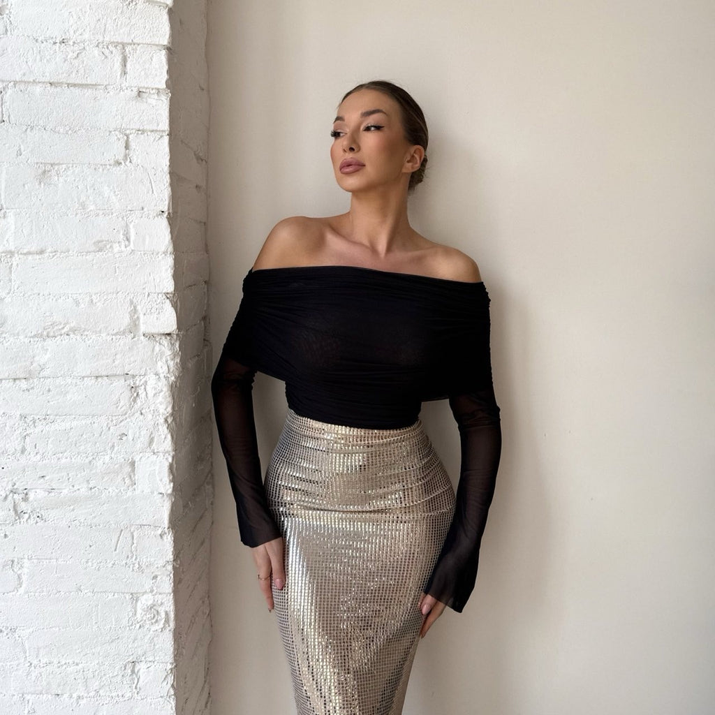 woman wearing black off shoulder top and silver sequin skirt woman wearing black off shoulder top and silver sequin skirt