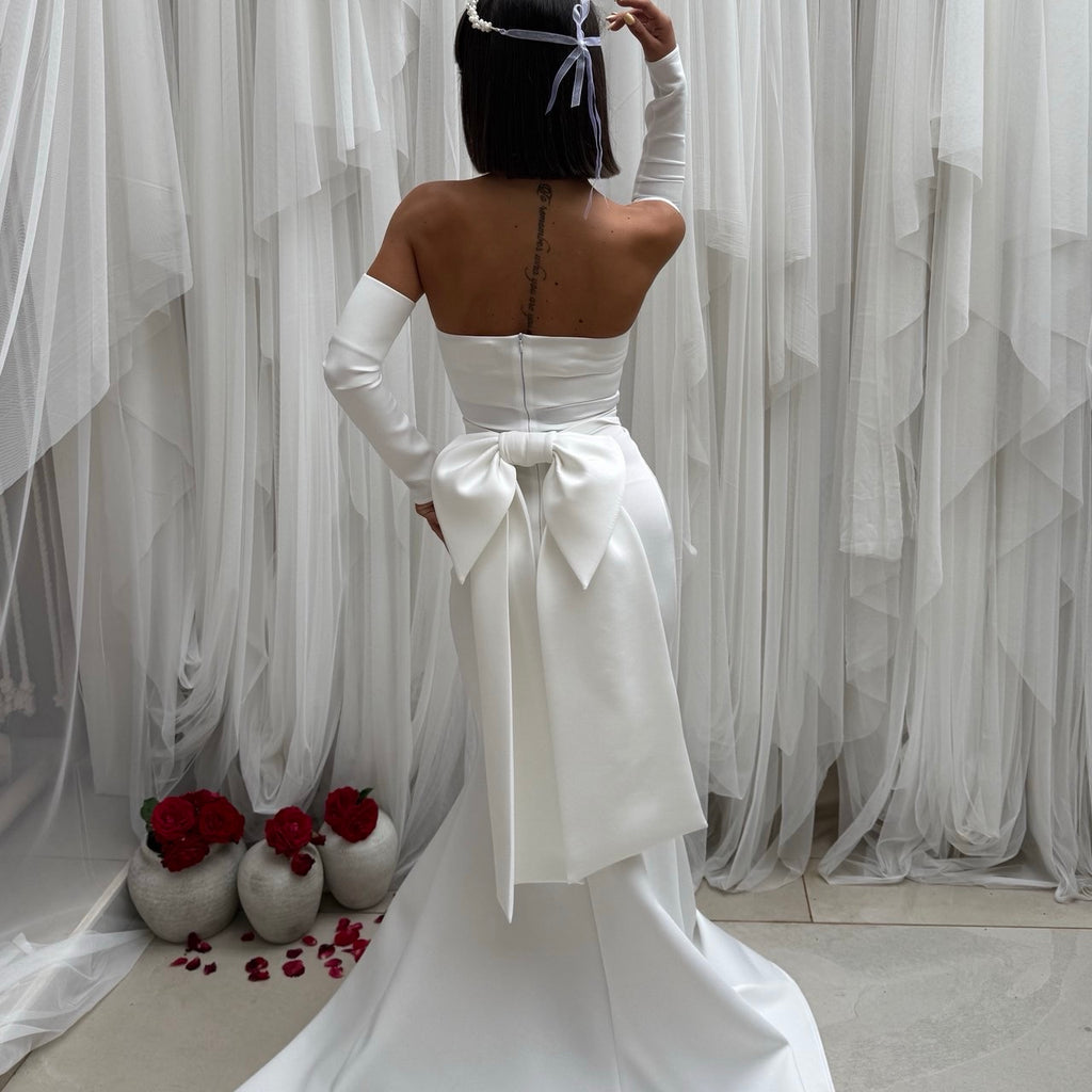 back view of elegant strapless white gown with large bow back view of elegant strapless white gown with large bow