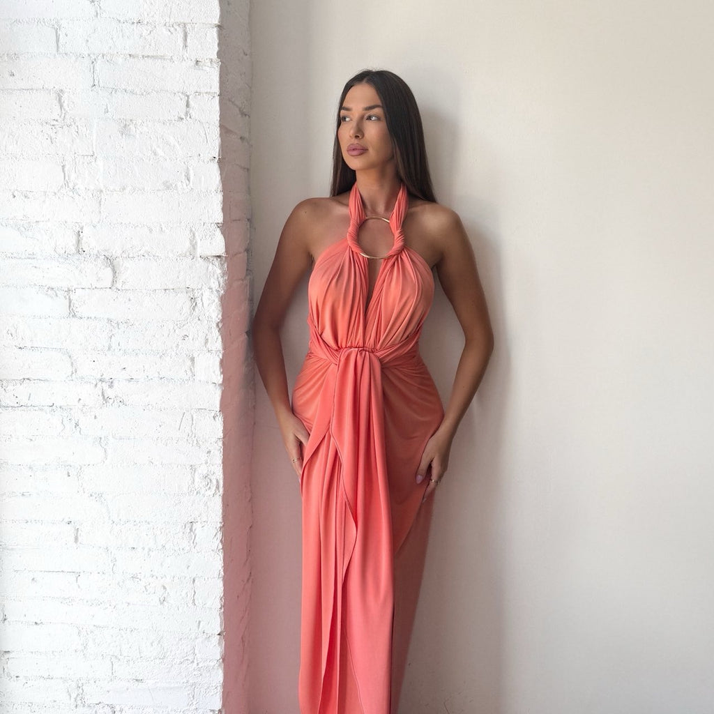 woman wearing halter neck coral dress woman wearing halter neck coral dress