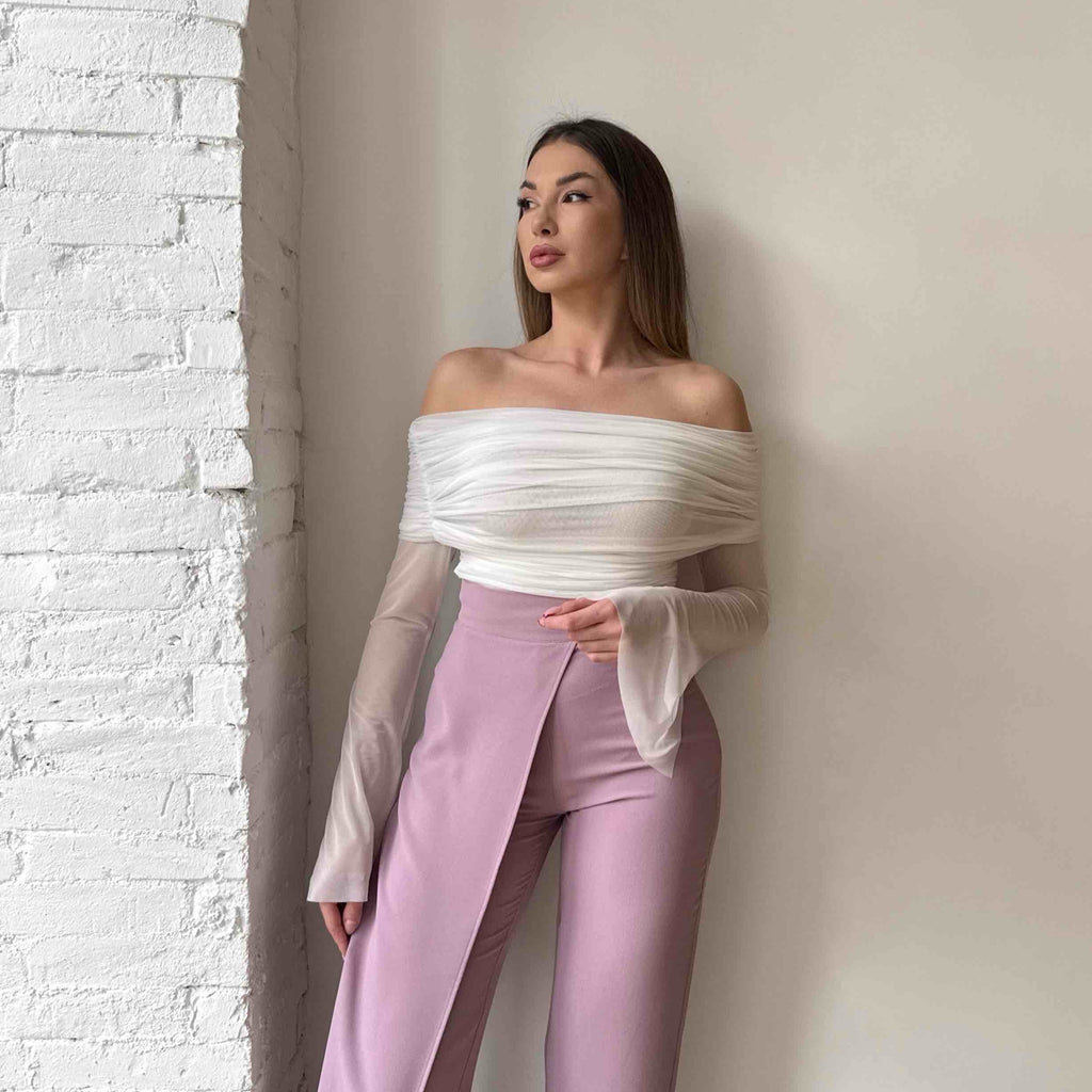 woman in off shoulder white top and pink wide leg pants woman in off shoulder white top and pink wide leg pants