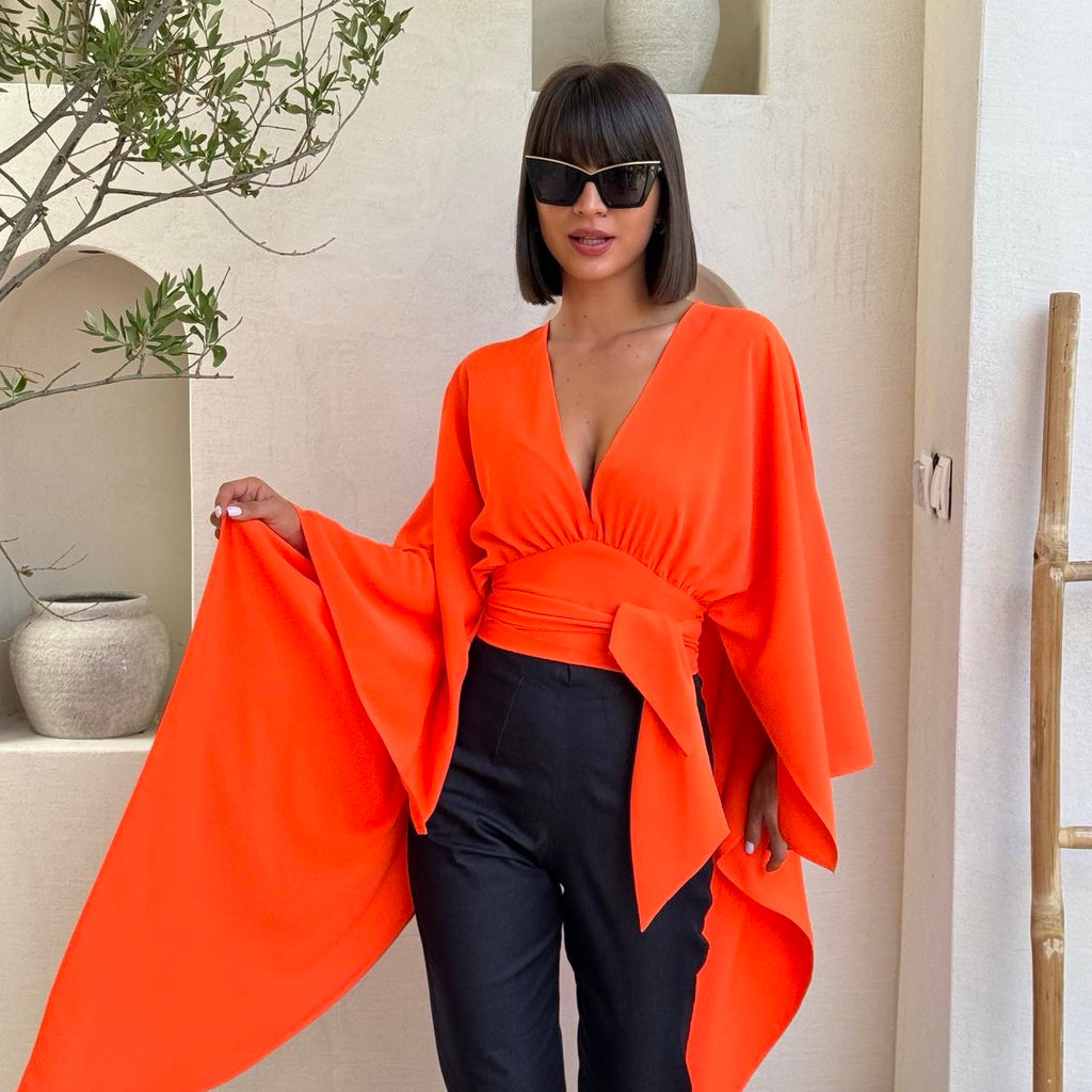 orange draped top with black pants orange draped top with black pants