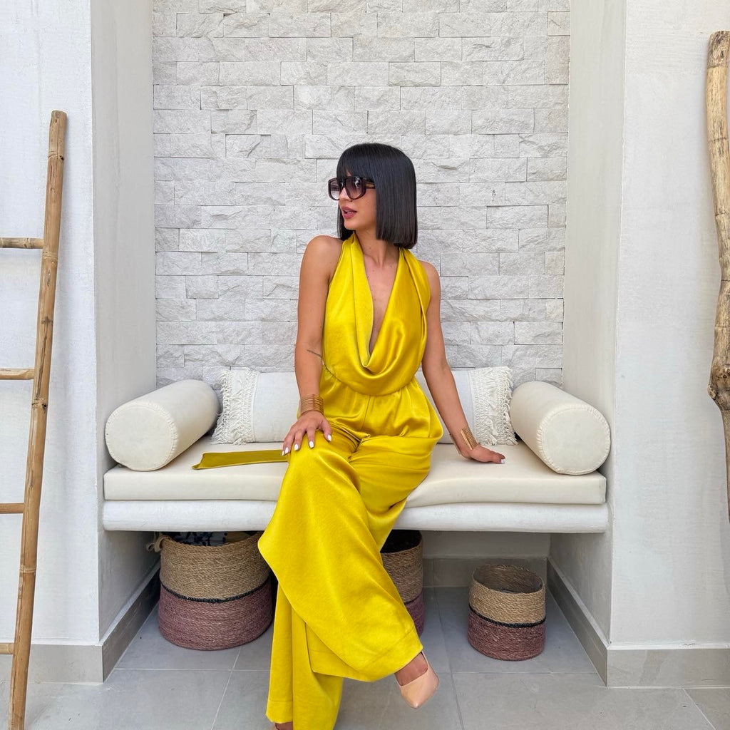 woman in yellow sleeveless dress sitting on bench woman in yellow sleeveless dress sitting on bench