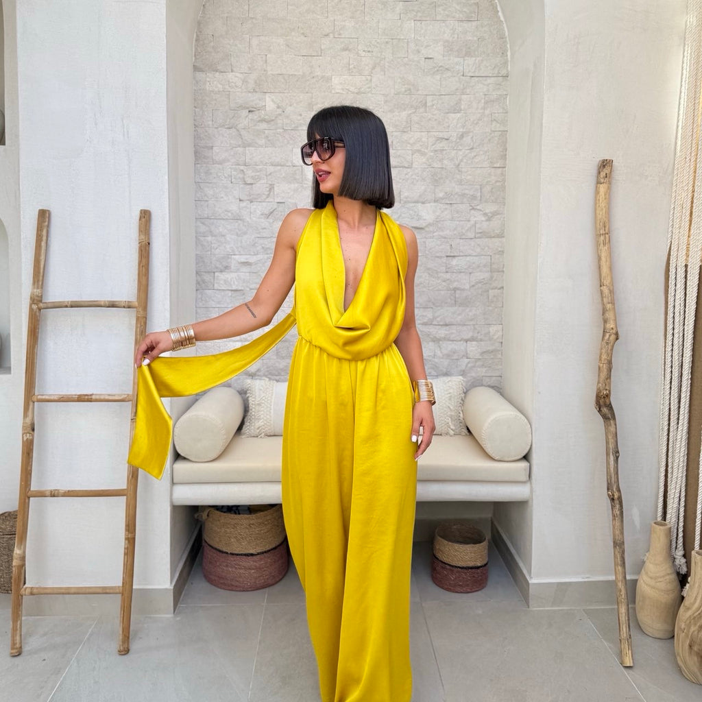 sleeveless yellow jumpsuit with draped neckline in modern room sleeveless yellow jumpsuit with draped neckline in modern room