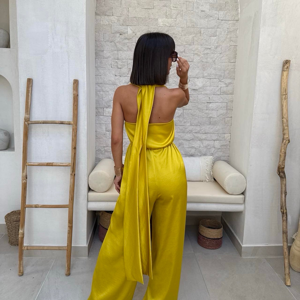 woman in yellow backless halter jumpsuit woman in yellow backless halter jumpsuit