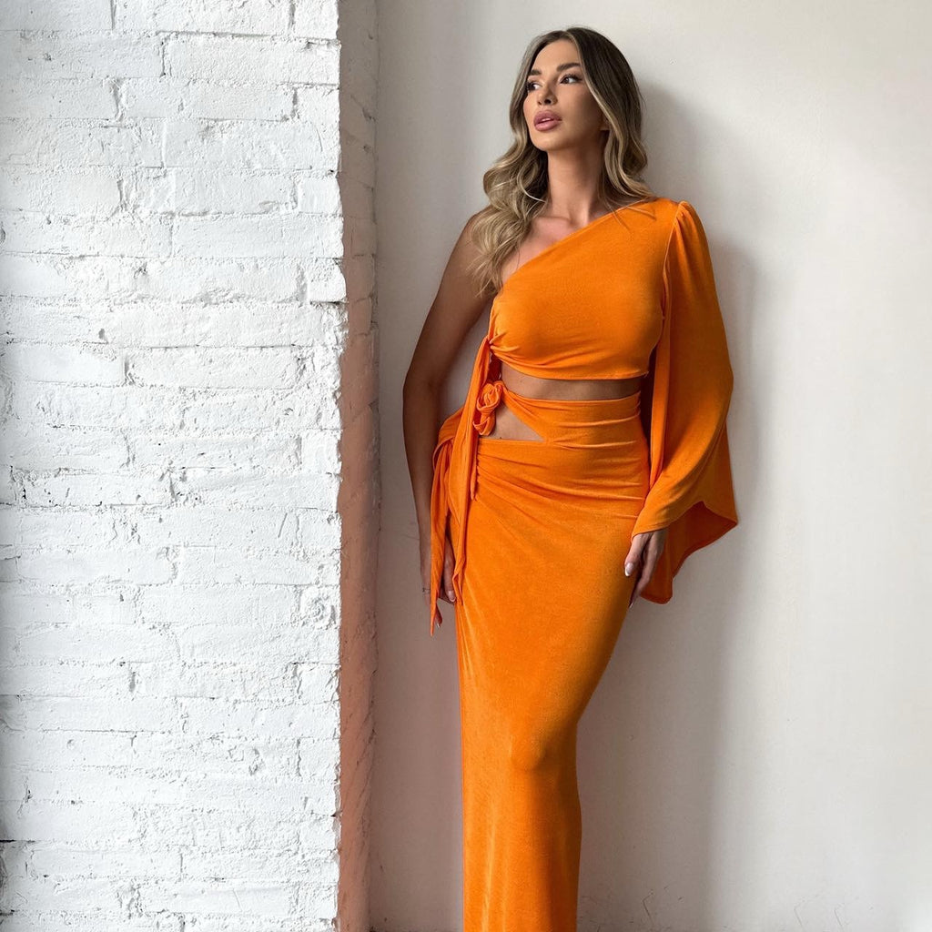 woman wearing one shoulder orange maxi dress woman wearing one shoulder orange maxi dress