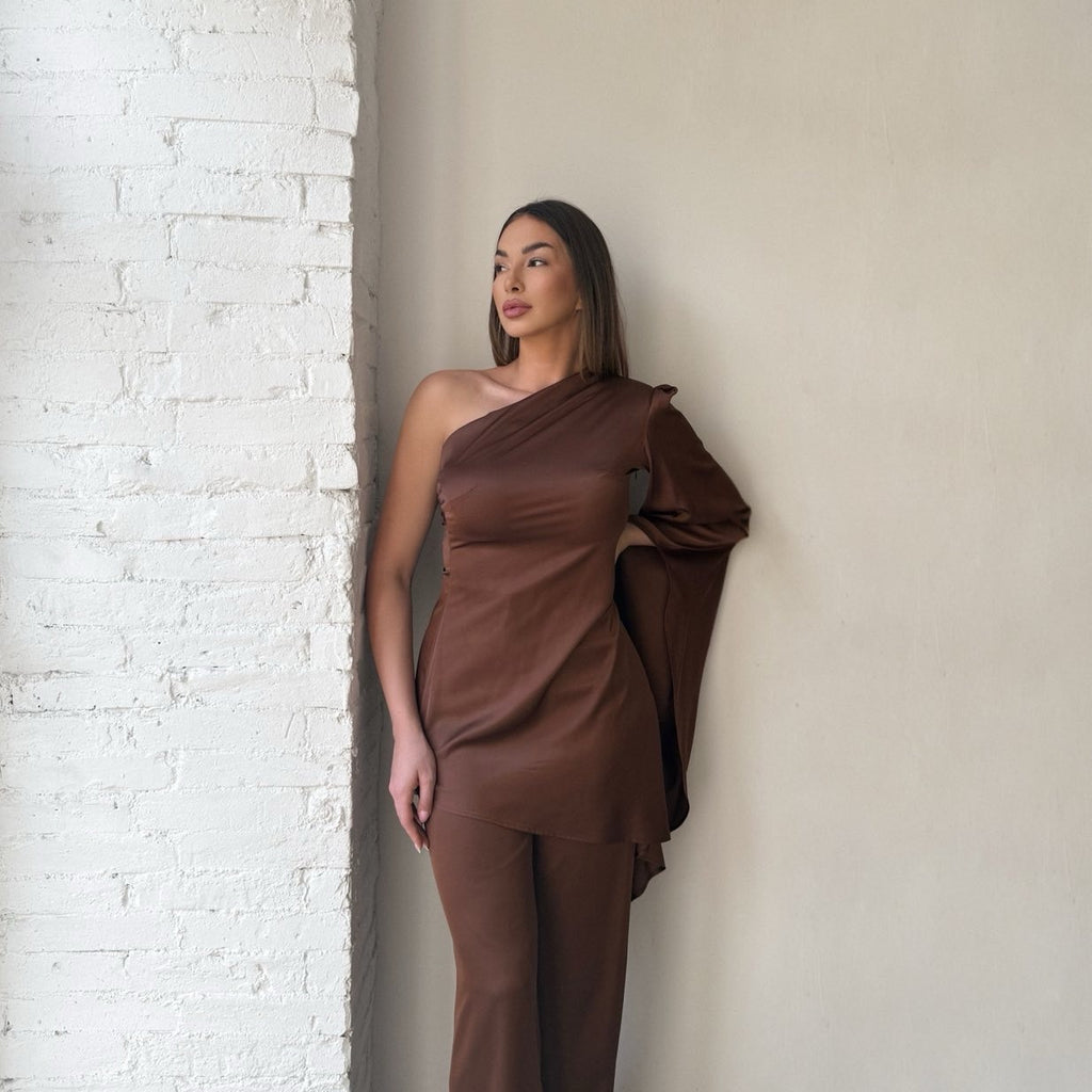 model wearing brown one shoulder dress model wearing brown one shoulder dress