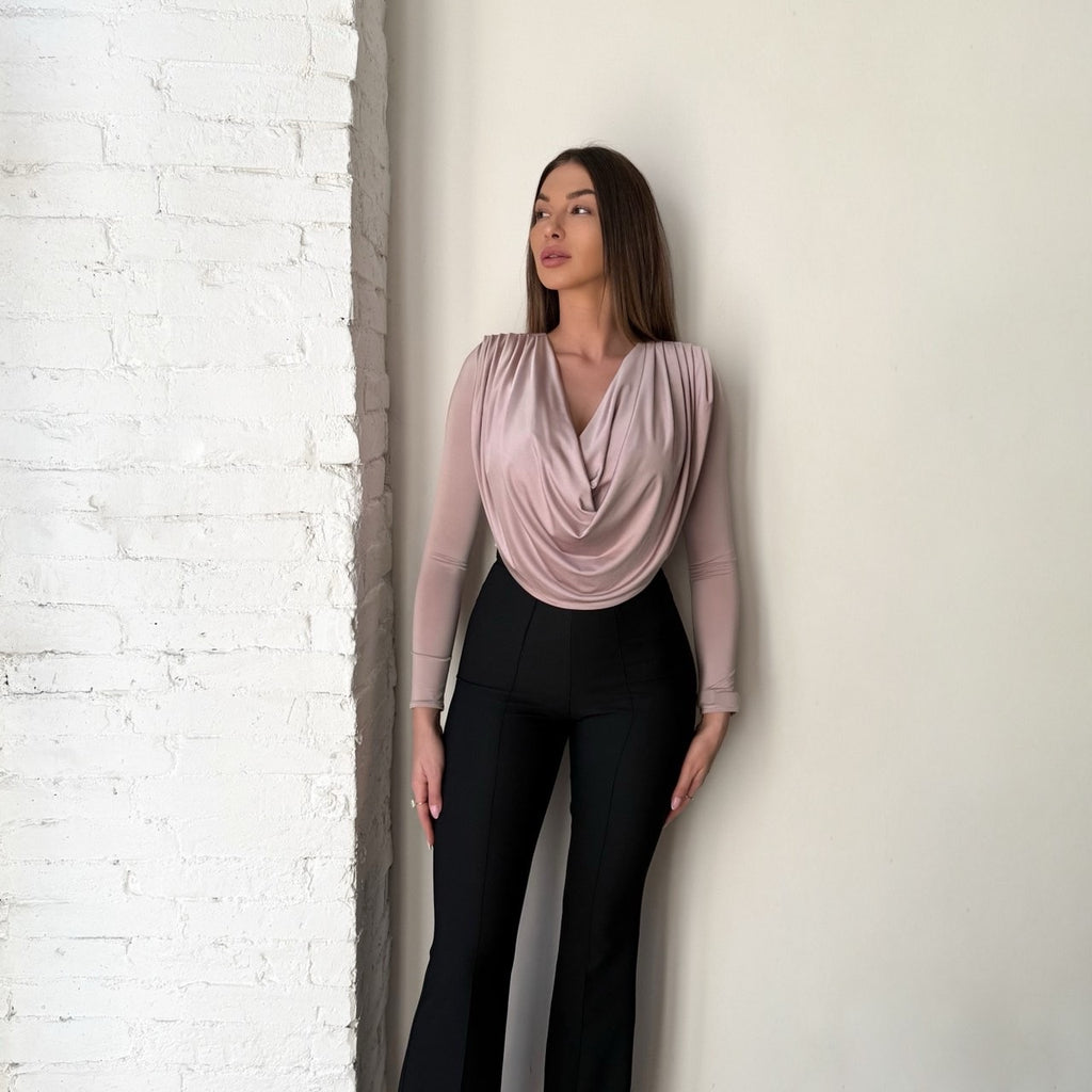 woman in draped blush top and black pants woman in draped blush top and black pants