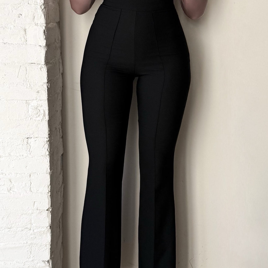 woman wearing black high waisted pants woman wearing black high waisted pants