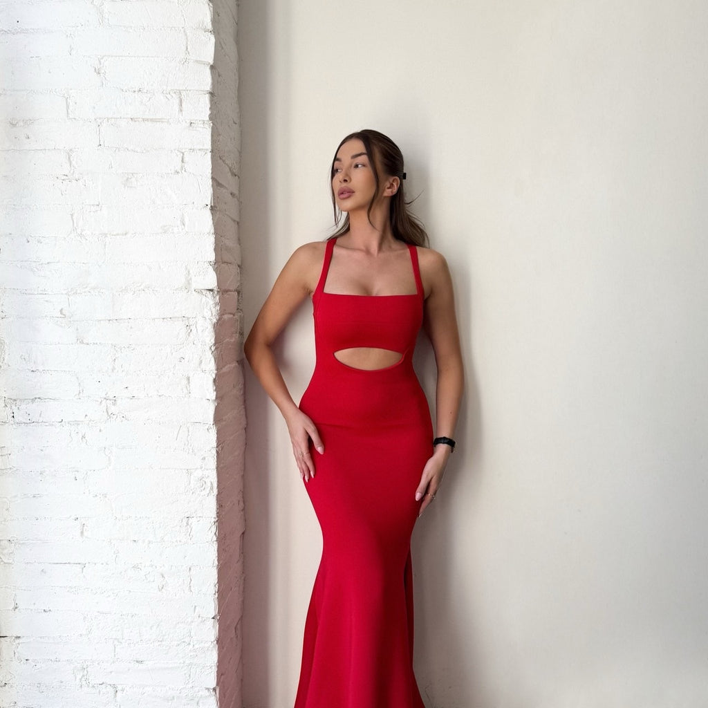 woman in red cutout dress against brick wall woman in red cutout dress against brick wall