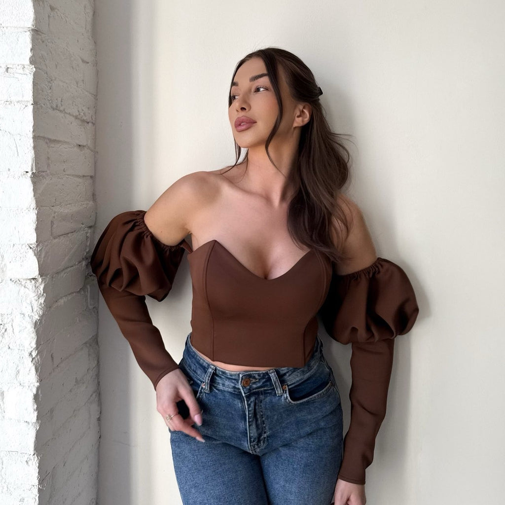 brunette woman in brown off shoulder top and jeans brunette woman in brown off shoulder top and jeans