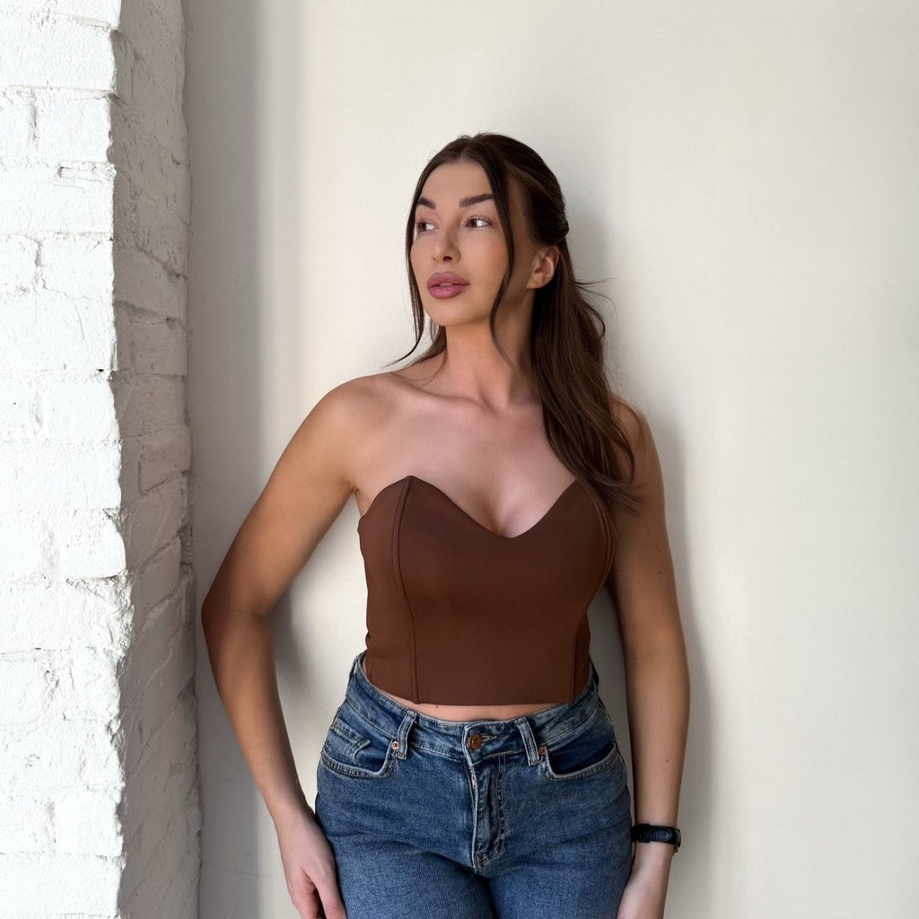 woman wearing brown tube top and blue jeans woman wearing brown tube top and blue jeans