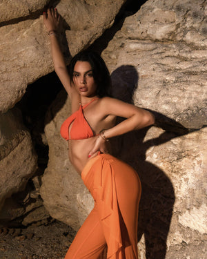 woman in orange two piece beach outfit
