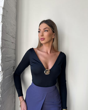 woman wearing black long sleeve top and purple skirt