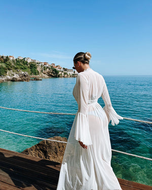 woman in white dress by the sea